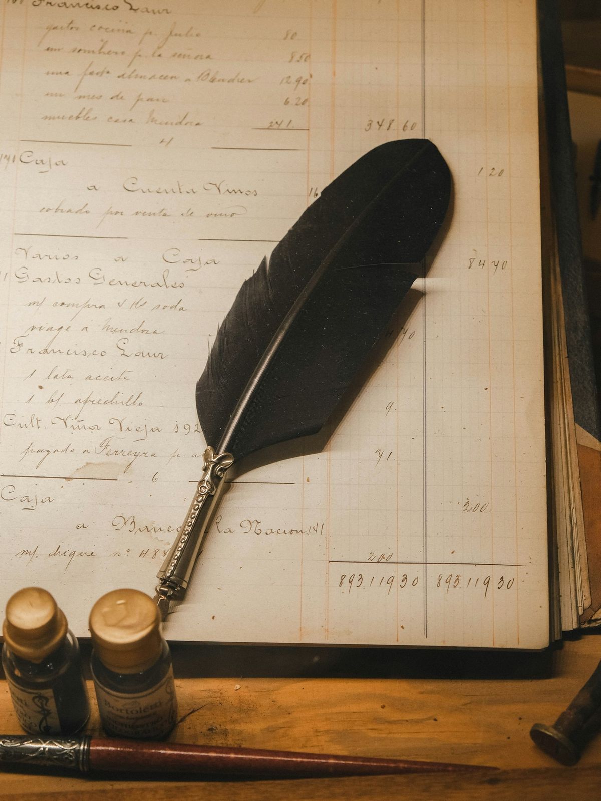 A feather quill resting on a vintage handwritten ledger — discipline, judgement and the craft of working with numbers